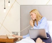 25545616-business-technology-internet-and-hotel-concept-happy-businesswoman-with-phone-and-lapto.jpg