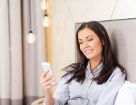 25546009-business-technology-internet-and-hotel-concept-happy-businesswoman-with-smartphone-lyin.jpg