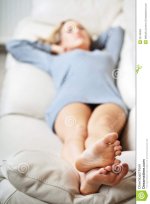 young-woman-lying-sofa-focus-her-feet-22745002.jpg
