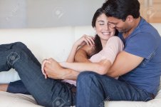 11682308-Man-kissing-his-fiance-in-the-neck-in-their-living-room-Stock-Photo.jpg