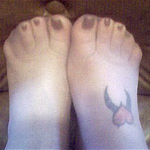 My feet in nylons, and showing my tickling tattoo on my right foot.