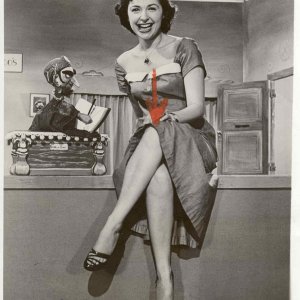 I don't know who she is, but the image is from the late 50s.  Don't you just LOVE that toe cleavage?