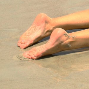 My feet at the beach, wet and sandy