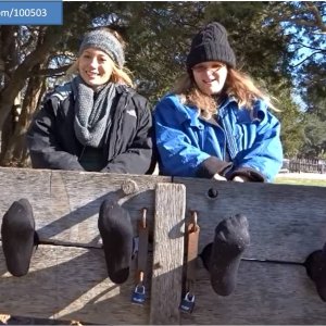 Locked in the stocks in black tights