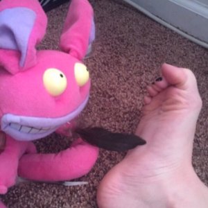 Ickis tickling my right foot with a feather!