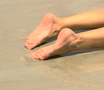 My feet at the beach, wet and sandy