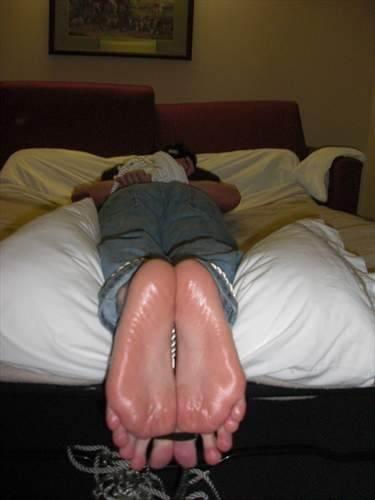 Tied face down, oiled and toe tied