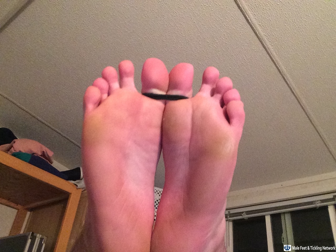 Toes tied for tickling.